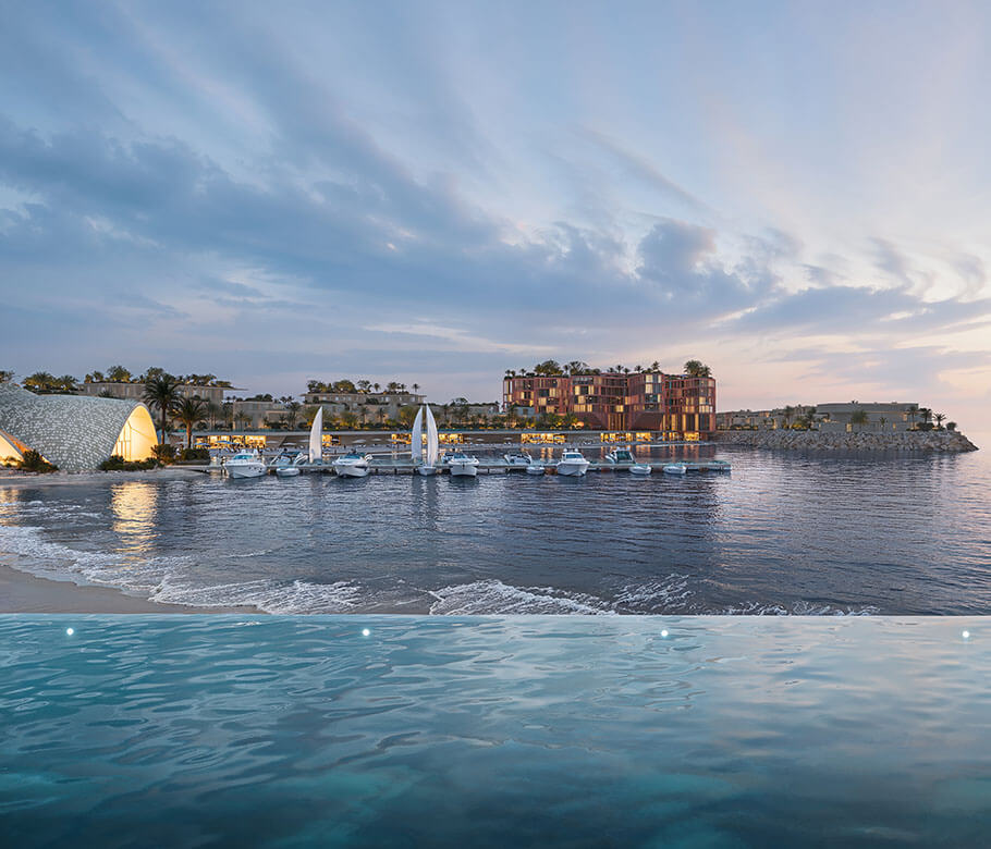 Waterfront luxury hotel complex at sunset